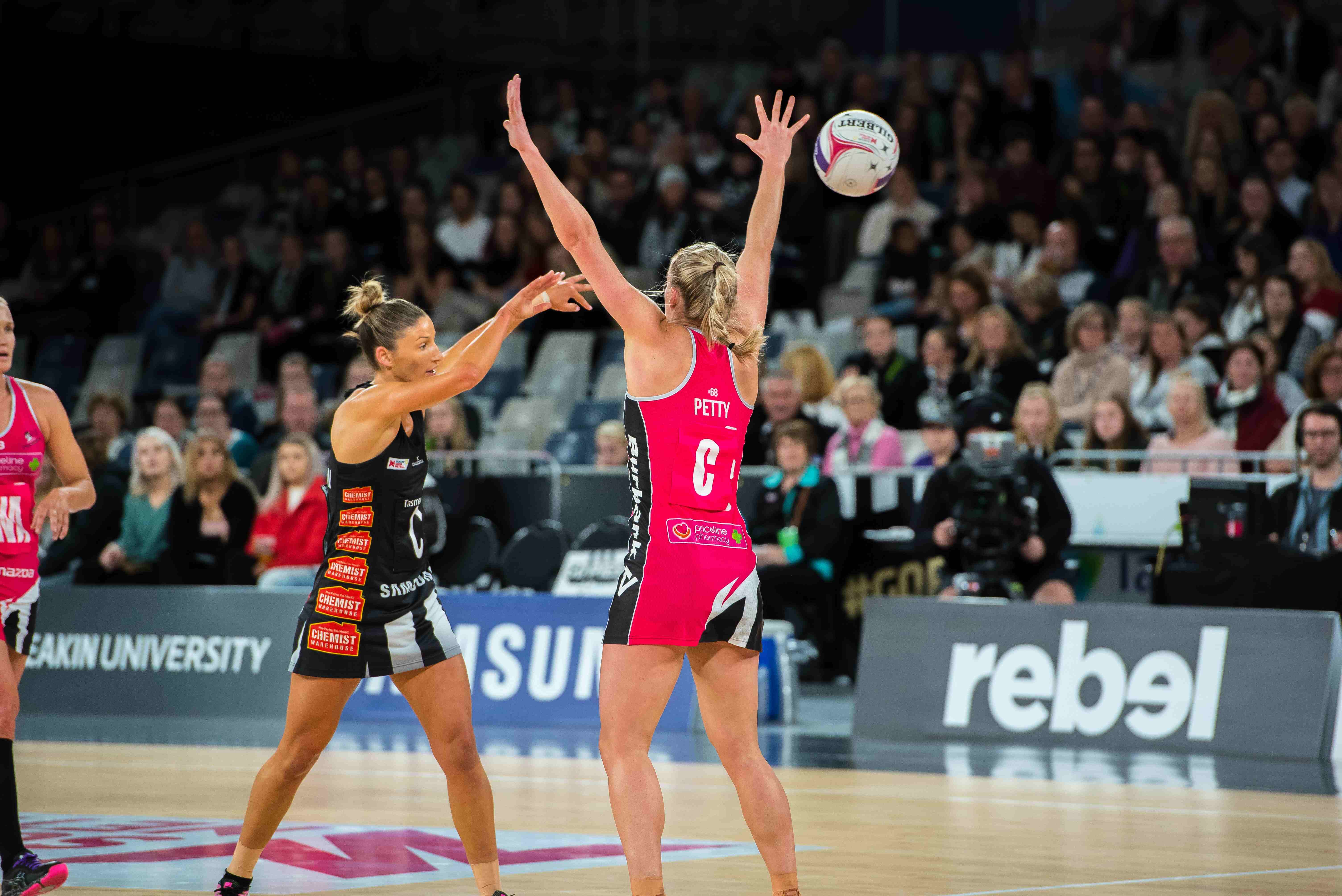 action shot of netball player making a pass